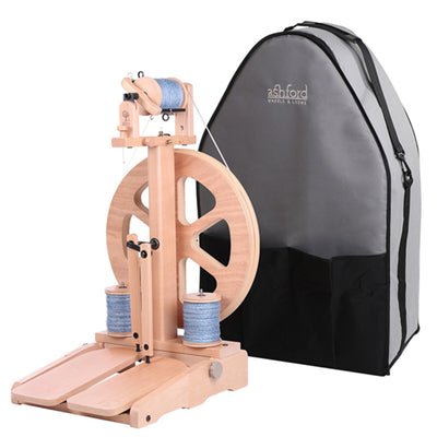 Wooden spinning wheel with gray carrying bag on a white background